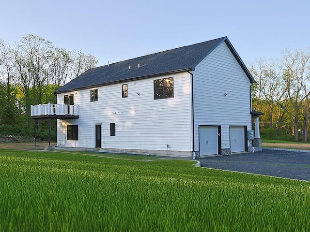 57 S Searsville Rd, Montgomery, NY 12549 - rear view of house with a garage, a yard, driveway, and a balcony