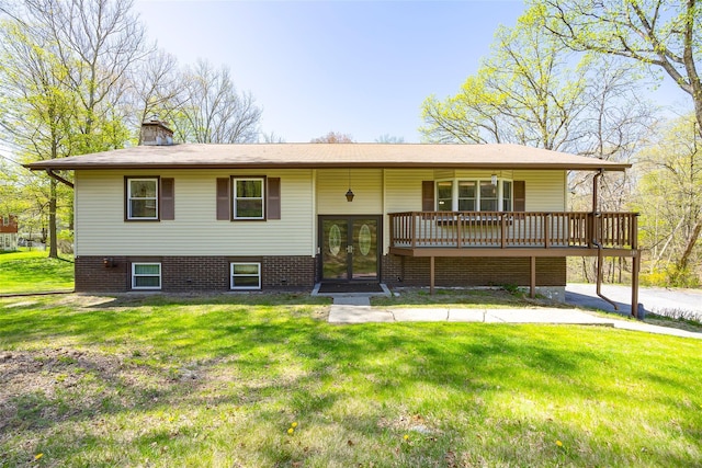 view of front of home featuring french doors, a front yard, a chimney, and a deck
