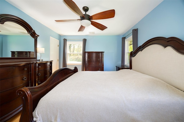 bedroom with multiple windows and ceiling fan