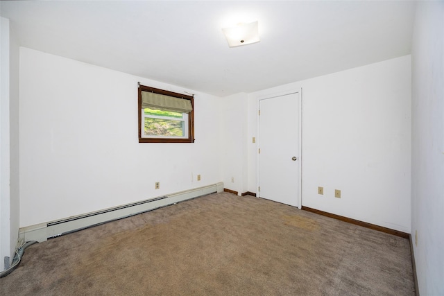 carpeted spare room featuring baseboard heating and baseboards