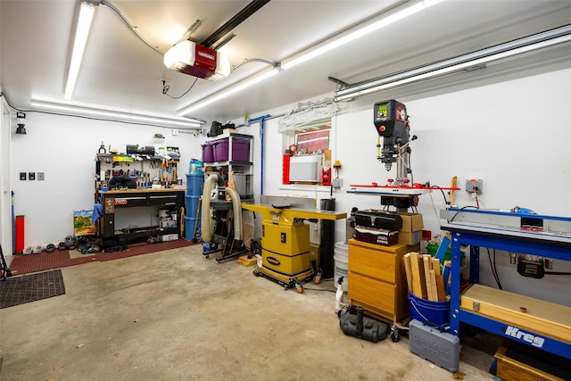 garage featuring a garage door opener and a workshop area