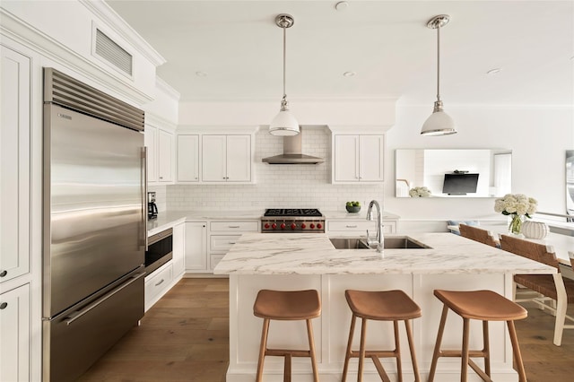 67 Old Boathouse Ln N, Hampton Bays, NY 11946 - kitchen with stainless steel built in fridge, a sink, wall chimney exhaust hood, stove, and a kitchen breakfast bar