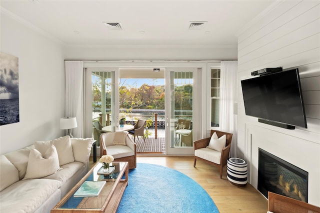 67 Old Boathouse Ln N, Hampton Bays, NY 11946 - living area featuring crown molding, wood finished floors, and a glass covered fireplace
