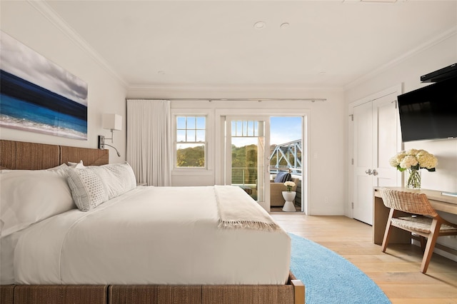 67 Old Boathouse Ln N, Hampton Bays, NY 11946 - bedroom featuring ornamental molding, multiple windows, access to exterior, and light wood finished floors