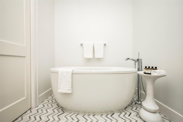 67 Old Boathouse Ln N, Hampton Bays, NY 11946 - bathroom with a soaking tub and baseboards
