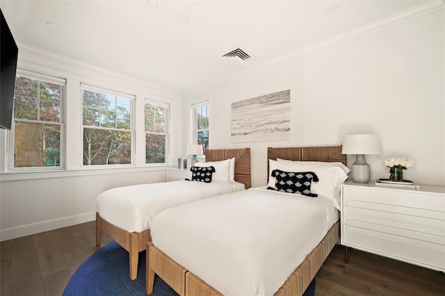 67 Old Boathouse Ln N, Hampton Bays, NY 11946 - bedroom featuring dark wood-type flooring, crown molding, and baseboards