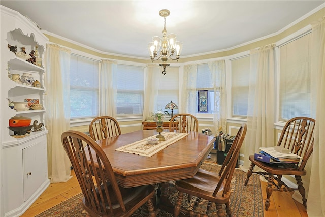 7 Southminster Dr, White Plains, NY 10604 - dining room with light wood-style flooring, a chandelier, crown molding, and healthy amount of natural light