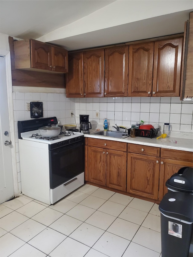 331 Jayne Blvd, Port Jefferson Station, NY 11776 - kitchen with gas range, light countertops, backsplash, and a sink