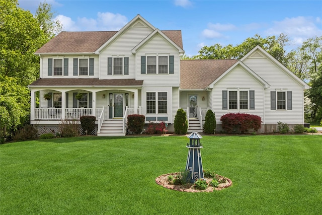 view of front of property featuring a shingled roof, covered porch, and a front yard