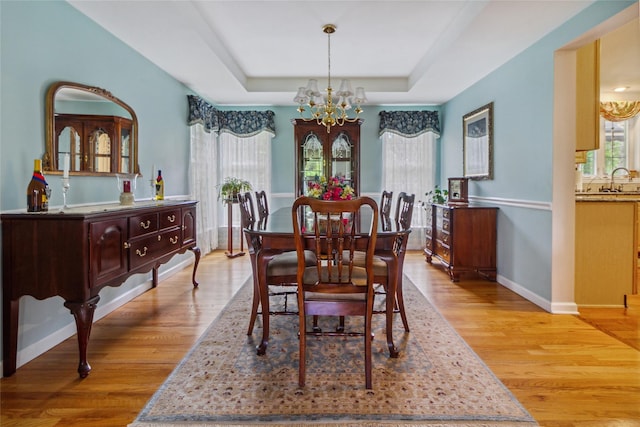 dining space featuring a chandelier, healthy amount of natural light, and light wood finished floors