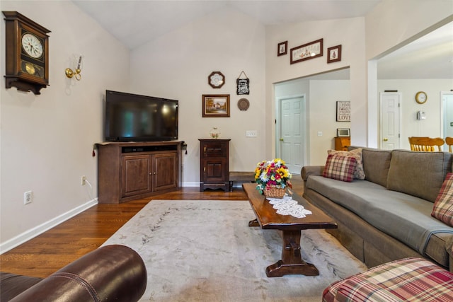 living area with dark wood-type flooring, baseboards, and high vaulted ceiling