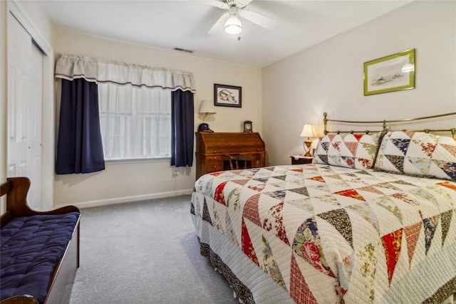 carpeted bedroom with a closet, baseboards, and a ceiling fan