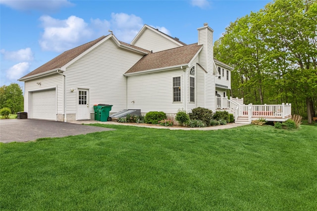 view of home's exterior featuring a chimney, an attached garage, a shingled roof, a deck, and driveway