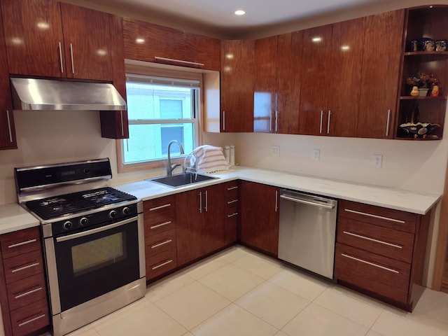kitchen featuring gas range oven, extractor fan, a sink, dishwasher, and light countertops