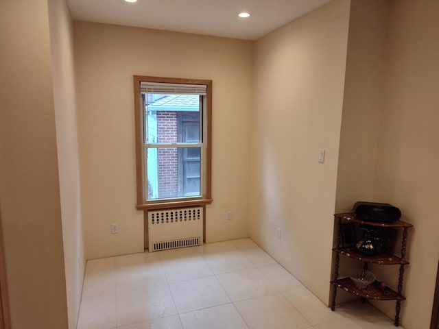 spare room with radiator heating unit, recessed lighting, and tile patterned floors