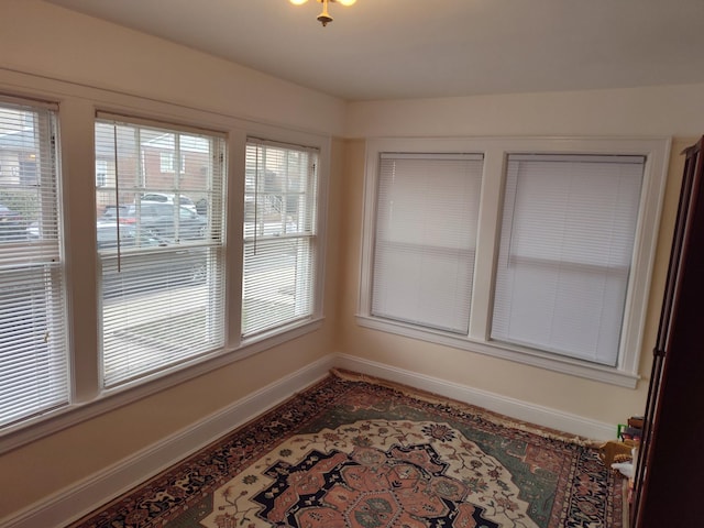 unfurnished dining area featuring baseboards
