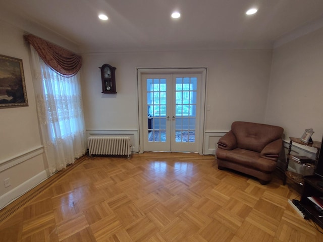living area with radiator, french doors, recessed lighting, and baseboards