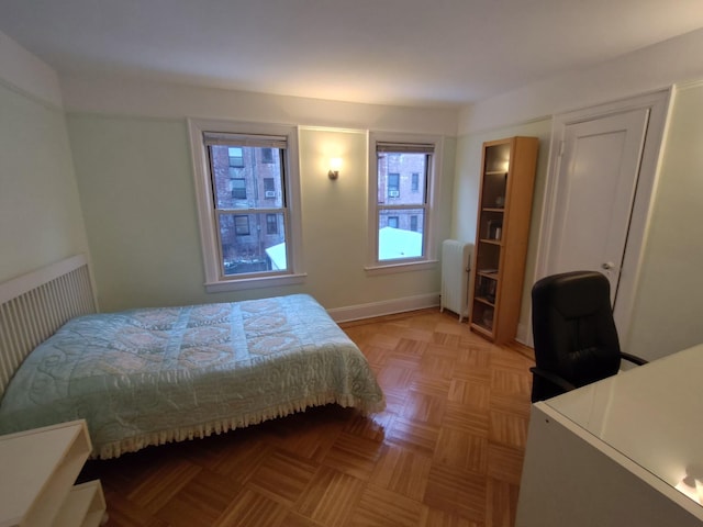 bedroom featuring radiator and a desk