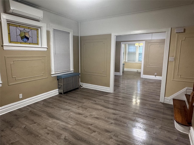 19-11 147th St, Flushing, NY 11357 - spare room with a wall mounted AC, dark wood-style floors, baseboards, and stairs