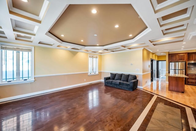 living area featuring coffered ceiling, ornamental molding, baseboards, light wood finished floors, and recessed lighting