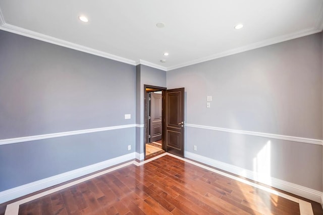 unfurnished room featuring wood finished floors, baseboards, ornamental molding, and recessed lighting
