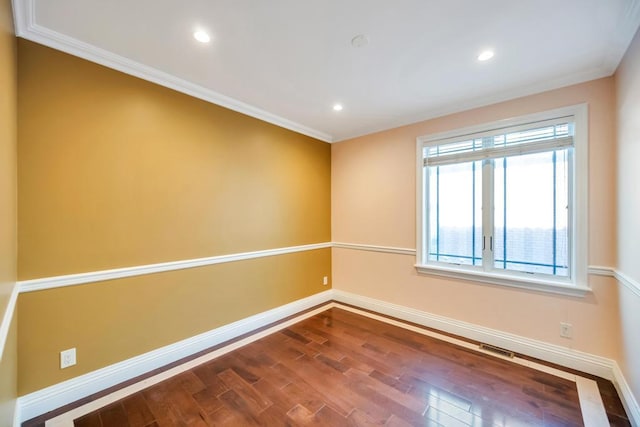 spare room with baseboards, dark wood-style floors, ornamental molding, and recessed lighting