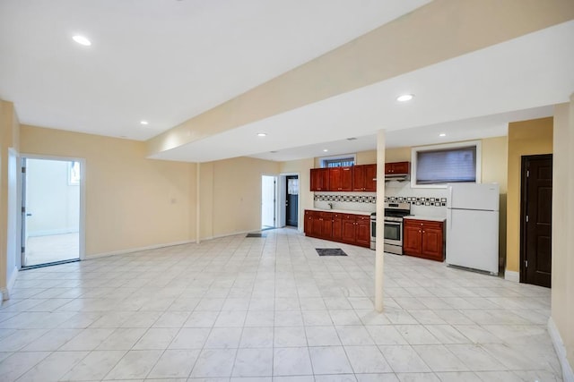 unfurnished living room featuring baseboards and recessed lighting