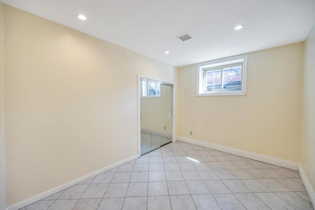 spare room featuring recessed lighting, baseboards, and light tile patterned floors
