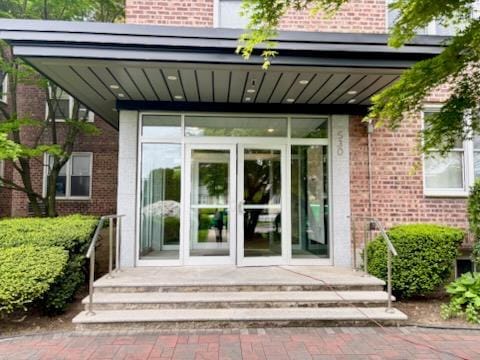 doorway to property with brick siding
