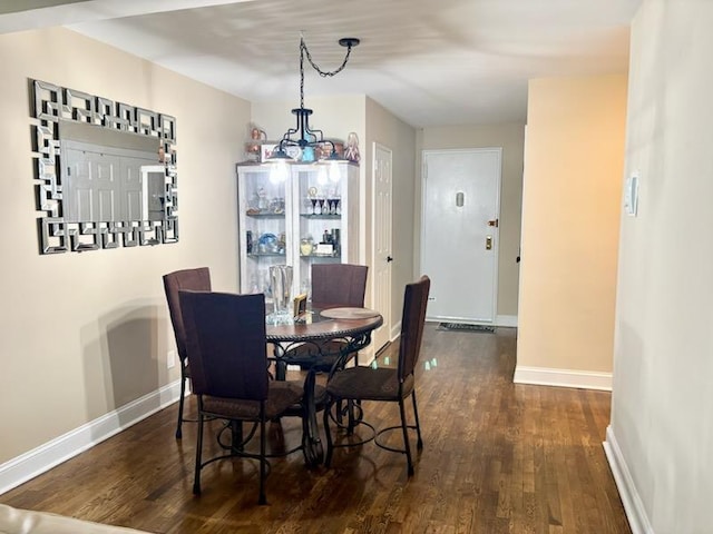 dining area with wood finished floors, baseboards, and a chandelier