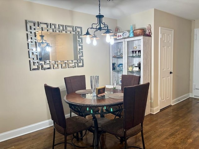 dining area featuring wood finished floors and baseboards