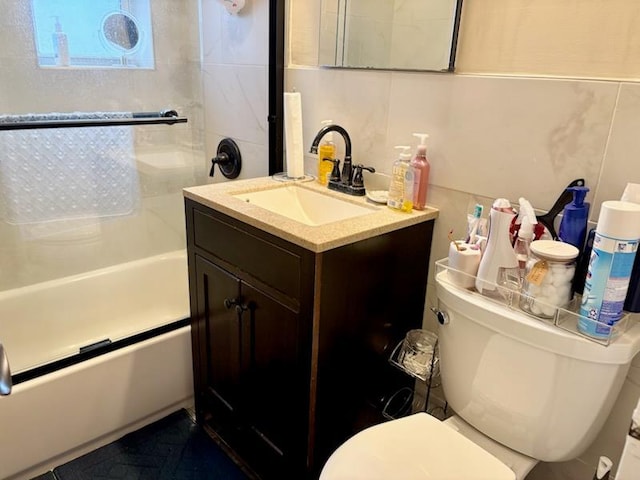 full bathroom featuring toilet, vanity, and  shower combination