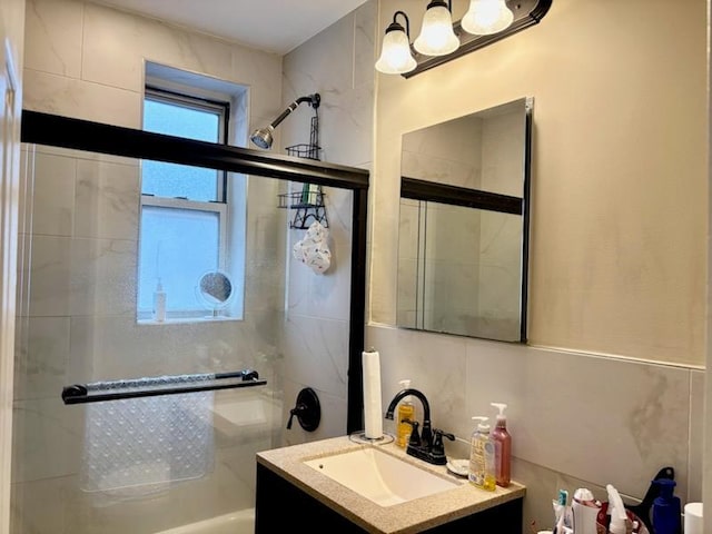 full bath featuring vanity and a shower