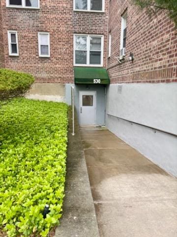 view of exterior entry with brick siding