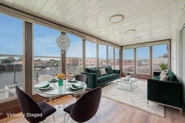 15940 95th St, Howard Beach, NY 11414 - sunroom with expansive windows, a water view, healthy amount of natural light, wood finished floors, and wooden ceiling
