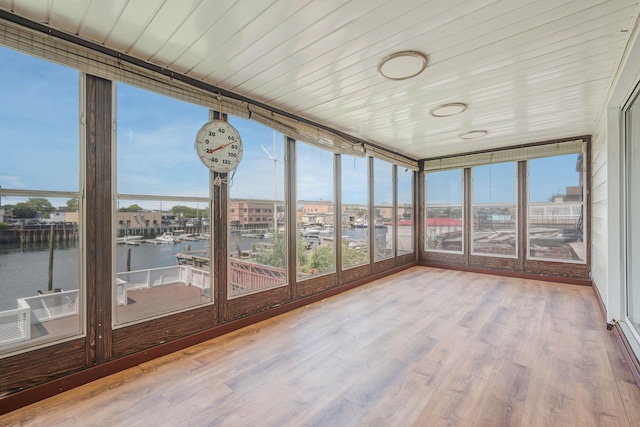 15940 95th St, Howard Beach, NY 11414 - unfurnished sunroom featuring a water view, expansive windows, wood finished floors, and healthy amount of natural light
