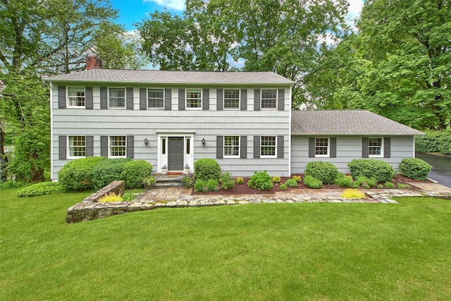 3 Kitchel Rd, Mount Kisco, NY 10549 - colonial inspired home featuring a chimney, a front lawn, and a shingled roof