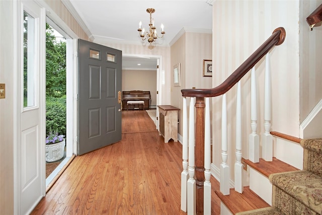 3 Kitchel Rd, Mount Kisco, NY 10549 - entryway featuring light wood-style floors, a chandelier, wallpapered walls, crown molding, and stairway