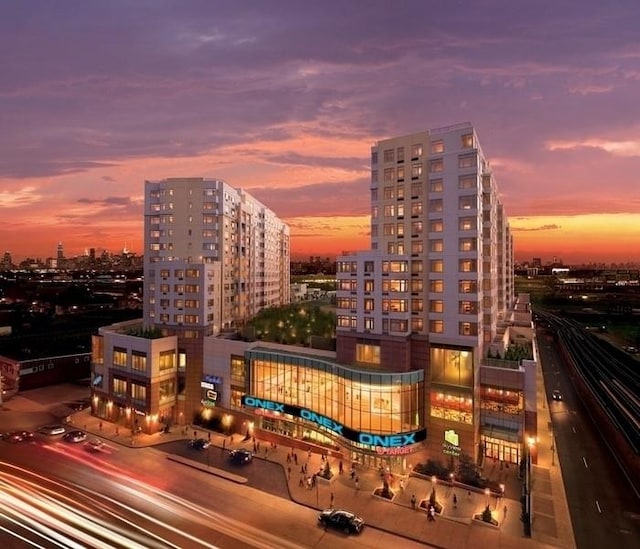 property at dusk featuring a view of city