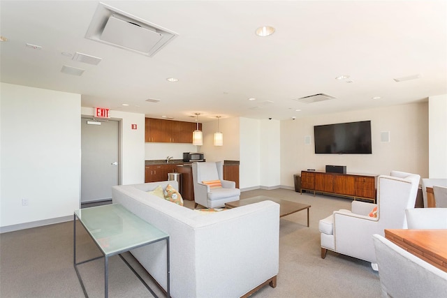 living area with recessed lighting, baseboards, and light colored carpet