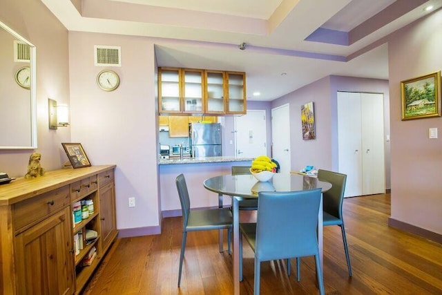 dining space with wood finished floors, baseboards, and recessed lighting