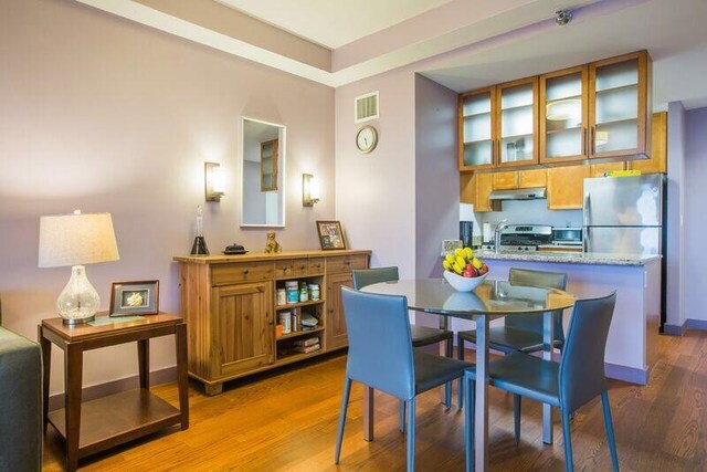 dining room with wood finished floors and baseboards
