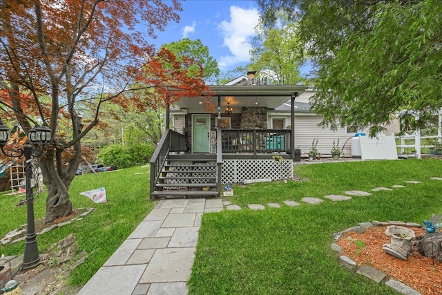back of property featuring covered porch, a lawn, and stone siding