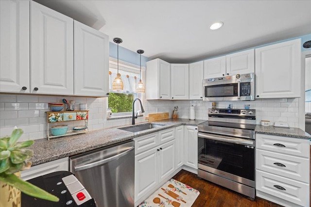 kitchen featuring appliances with stainless steel finishes, a sink, and white cabinetry
