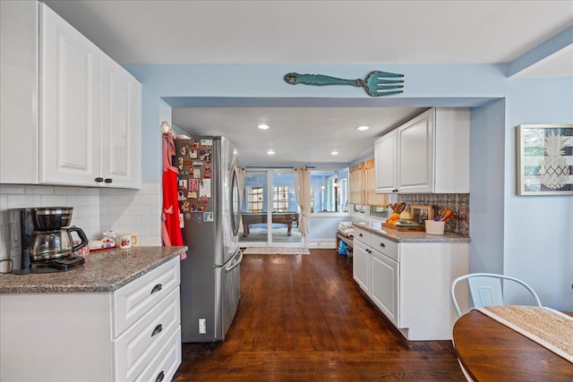 kitchen featuring freestanding refrigerator, dark wood-type flooring, white cabinetry, tasteful backsplash, and recessed lighting