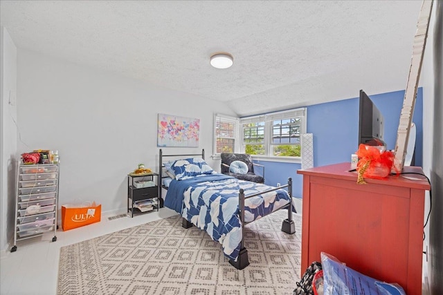 bedroom featuring a textured ceiling, lofted ceiling, and baseboards
