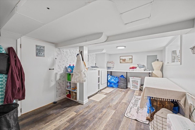 basement with washer and clothes dryer and wood finished floors