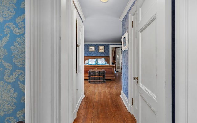 corridor with wallpapered walls and wood finished floors