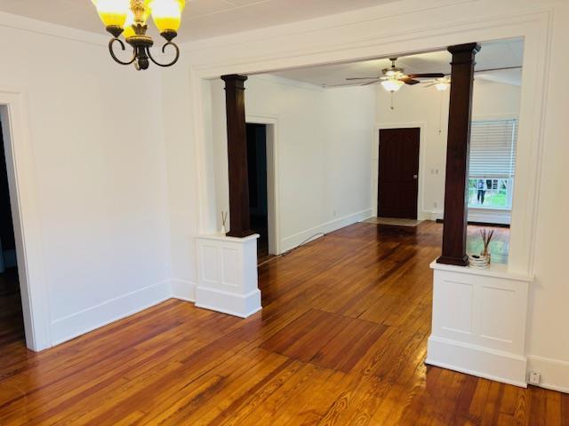 1358 Rte 44, Pleasant Valley, NY 12569 - spare room with wood finished floors, ornate columns, a chandelier, a ceiling fan, and baseboards