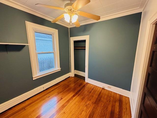 1358 Rte 44, Pleasant Valley, NY 12569 - unfurnished bedroom with baseboards, wood finished floors, crown molding, ceiling fan, and a closet